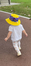 Load image into Gallery viewer, Sunsafe hat (yellow and purple) - Daring Dinosaurs
