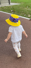 Load image into Gallery viewer, Sunsafe hat (yellow and purple) - Daring Dinosaurs

